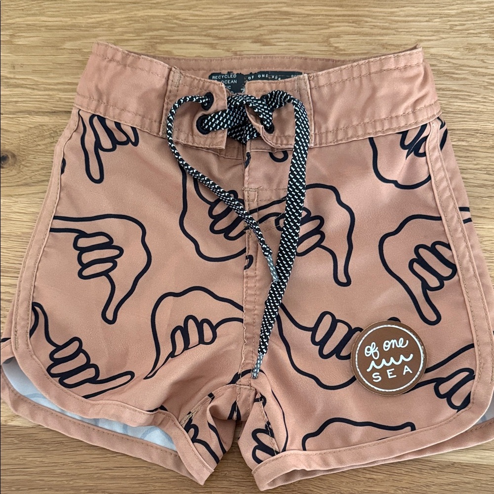 Of One Sea Peach Kids' Swim Trunks with Shaka Print